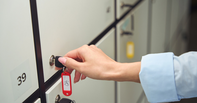 Woman unlocking a storage locker