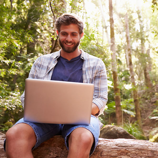 A person is shown comfortably paying their storage bill on a tablet while sitting in nature, highlighting the ease and flexibility of the process. image4.jpg