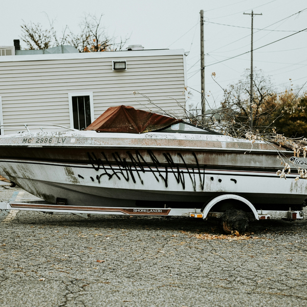 Graffiti sprayed on a boat parked outside