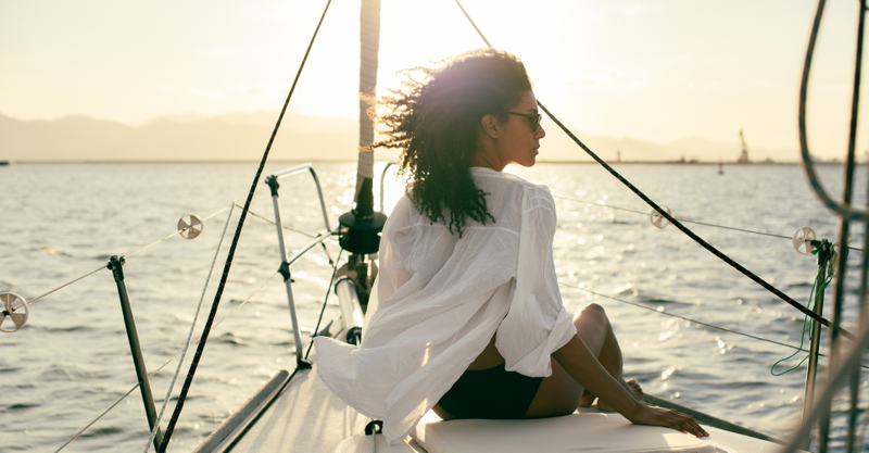 Woman on a boat at sundown