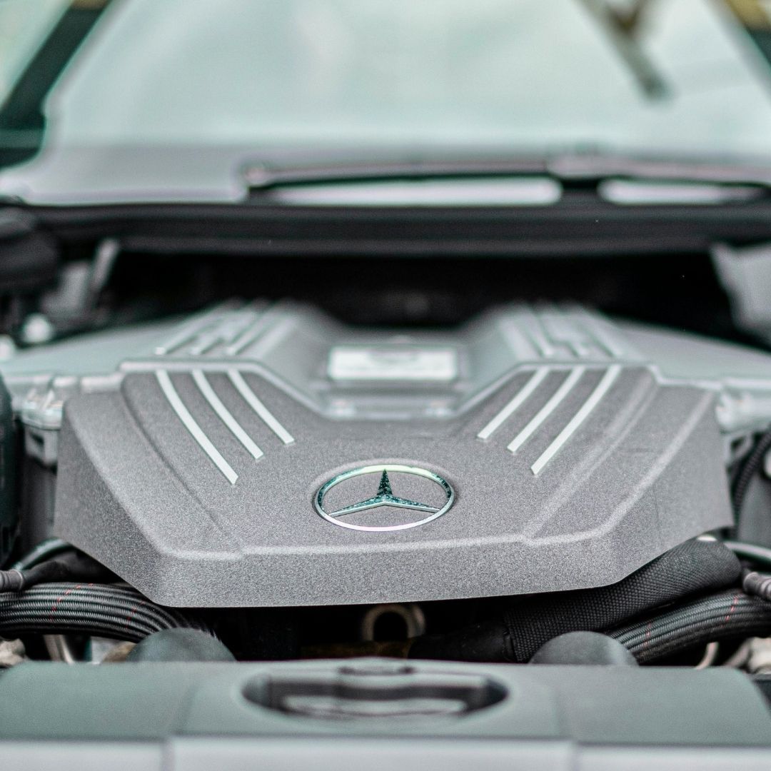 A detailed close-up shows the clean and complex engine bay of a high-performance foreign vehicle.