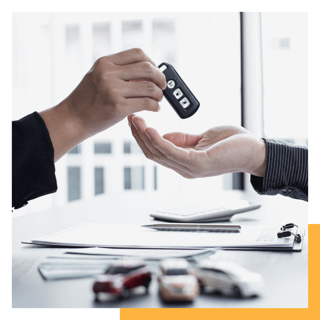 seller handing car keys over to buyer
