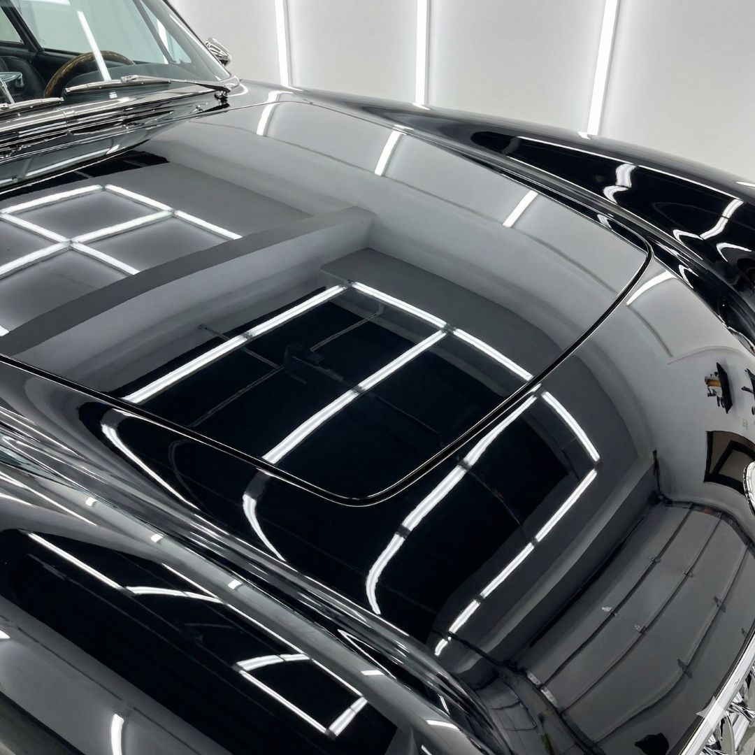 A mirror-like, high-gloss finish on a restored classic car demonstrates our commitment to superior paint and bodywork.