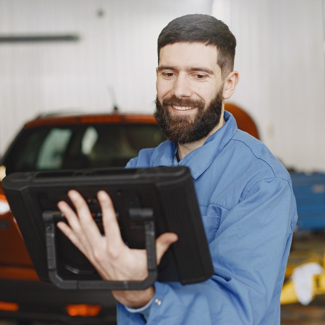 mechanic taking notes on tablet