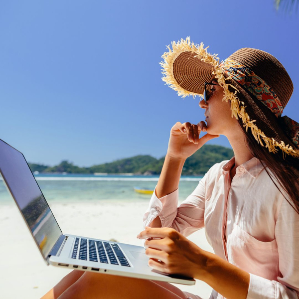 woman on beach with computer