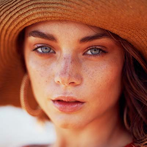 woman with sun hat tanning