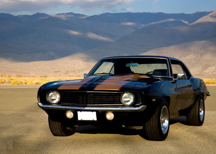 vintage car with mountain behind