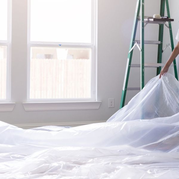 Covering floors with drop cloths or plastic sheets