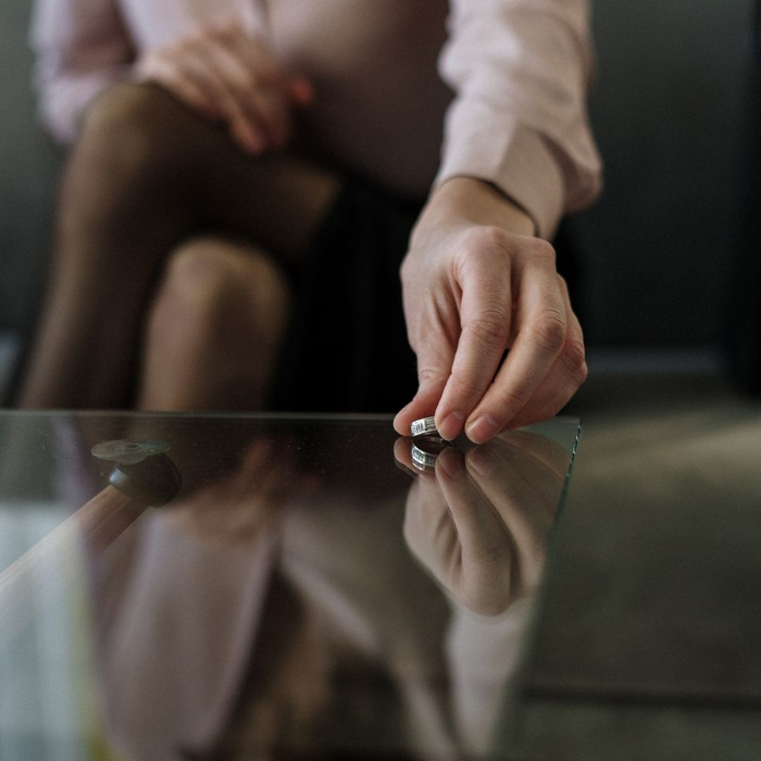 woman putting wedding ring on table 