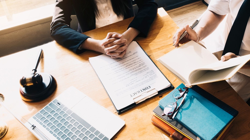 The desk of a family lawyer with a contract on it