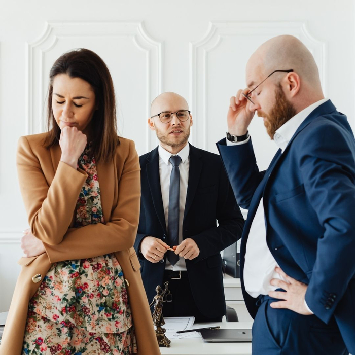 couple fighting with each other in front of divorce lawyer 