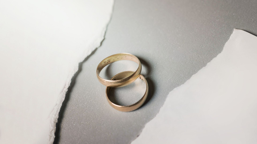 wedding rings and torn paper