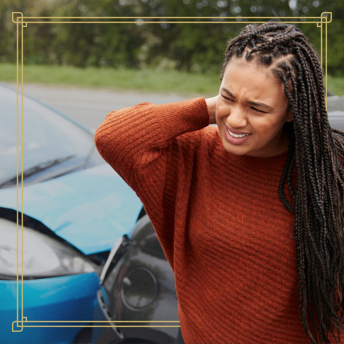 a woman holding her neck in pain after an auto accident