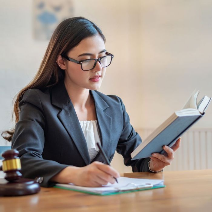 lawyer looking at book and taking notes