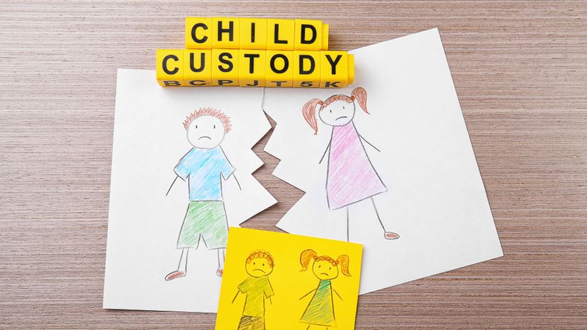 A torn child's drawing and blocks saying "child custody"