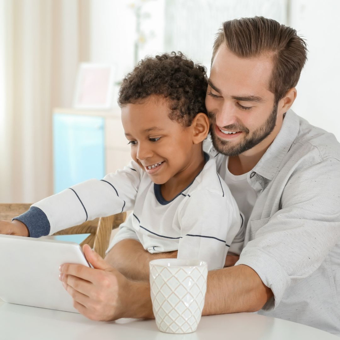 A dad and his son watching a video