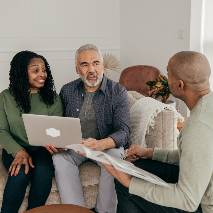 man having a conversation with a couple. 