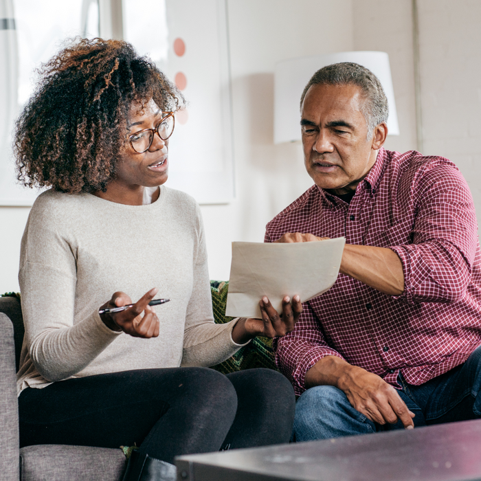 Man discussing a document with a woman. 