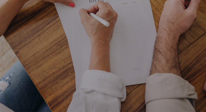 Man and woman writing on a paper