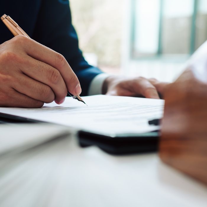 Person writing on a document