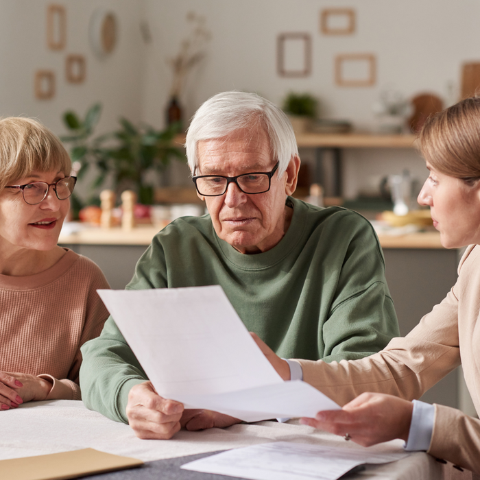 man and woman discussing a document with a woman. 