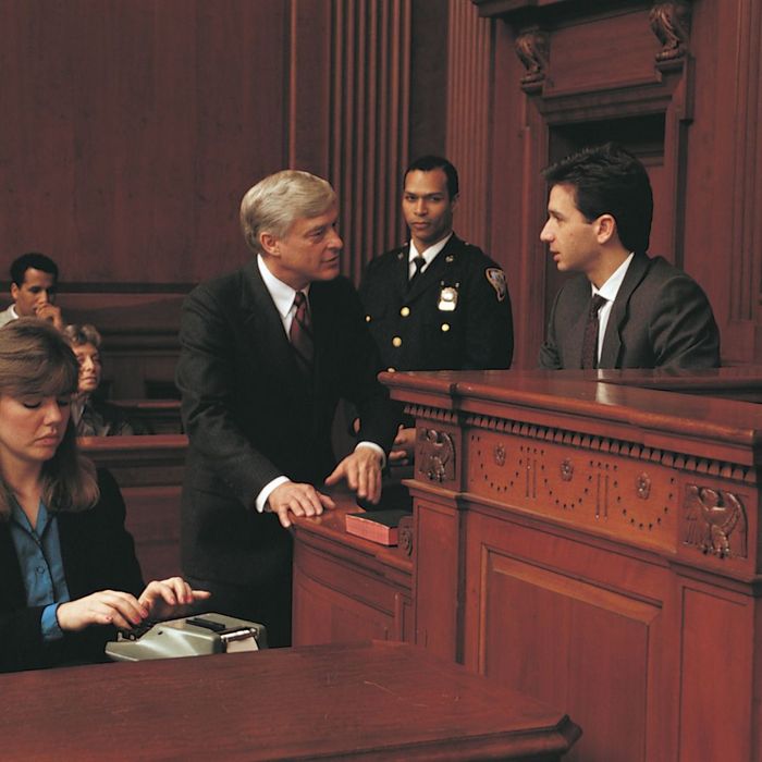 A Lawyer talks to a witness in a court room