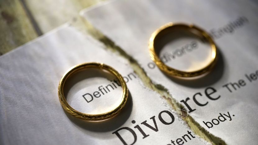 wedding rings split by a divorce paper