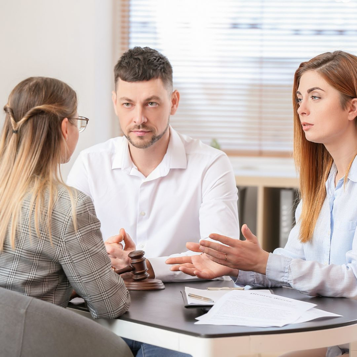 lawyer talking to husband and wife