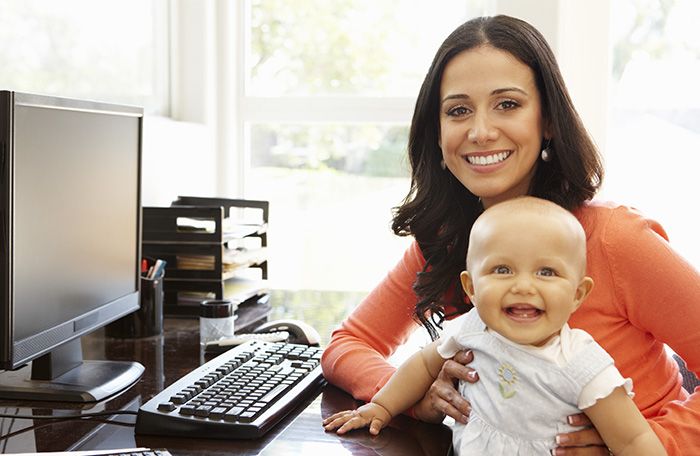 woman at computer with baby