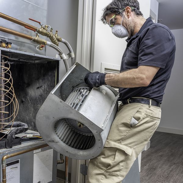 HVAC technician installing air filter