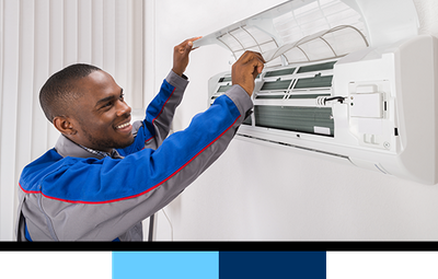 Technician repairing wall-mounted AC unit