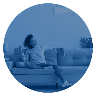 Woman relaxing and enjoying air conditioning from a small wall unit.