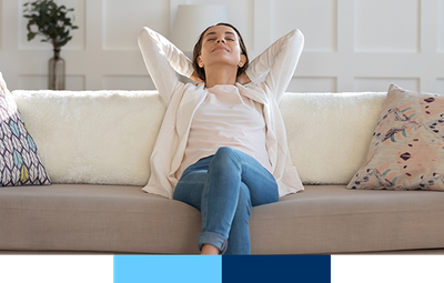 Happy woman leaning back on couch