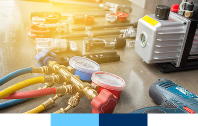 A variety of HVAC tools laid out on table