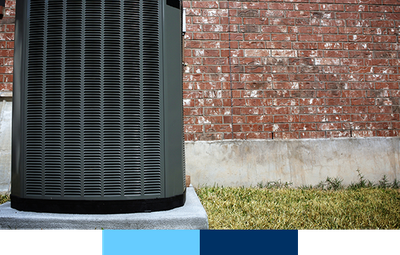 Air conditioner in front of brick wall.