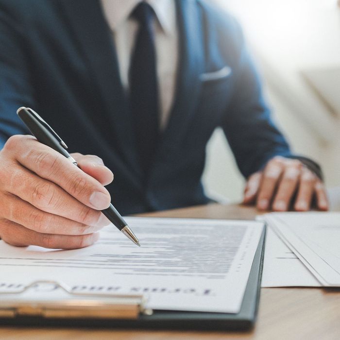 man in suit looking at documents