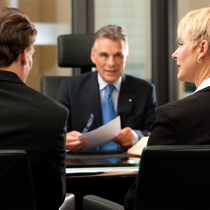 A couple speaking with a lawyer