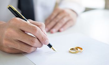 man signing divorce papers