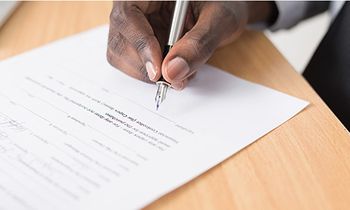 man signing legal paperwork