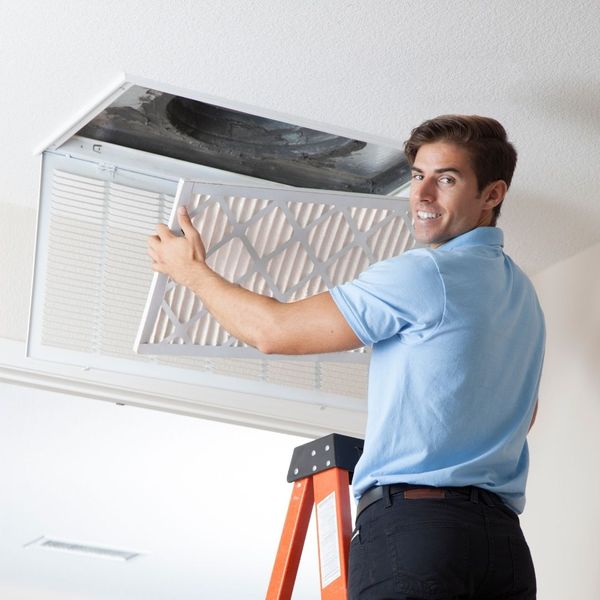 HVAC technician changing air filter