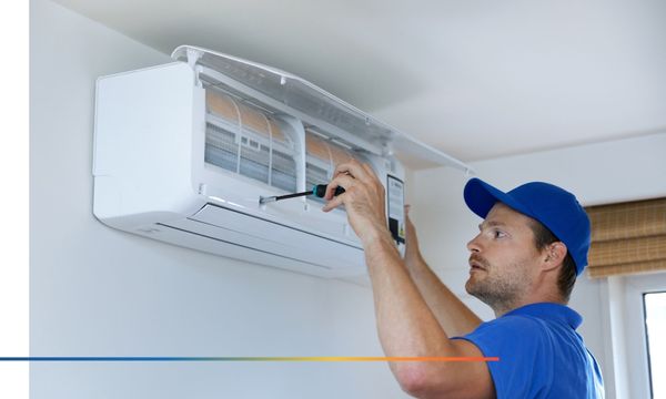 Technician repairing an AC unit