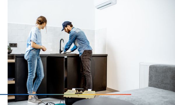 Plumber fixing kitchen sink