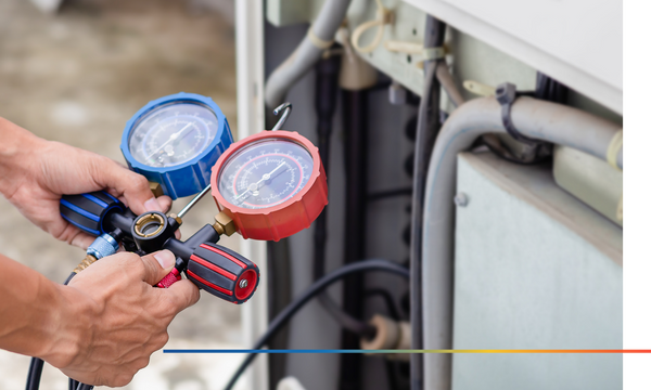 HVAC service technician using gauges to check refrigerant and add refrigerant.