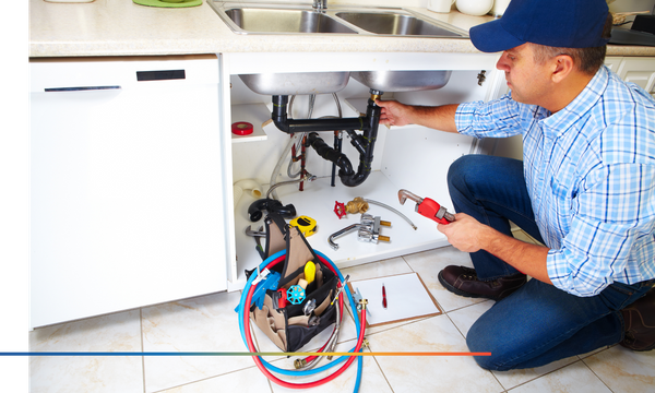 plumber working on sink