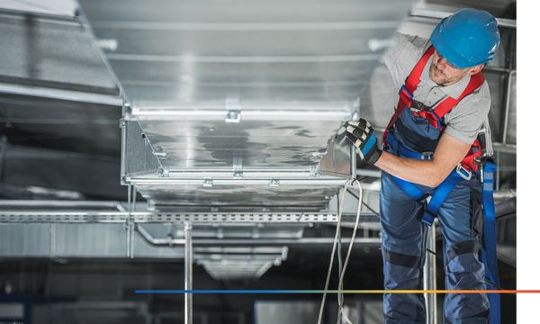 Person working on commercial air duct