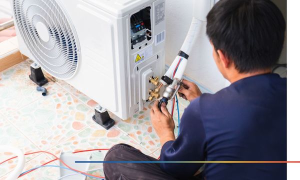 HVAC worker fixing AC unit