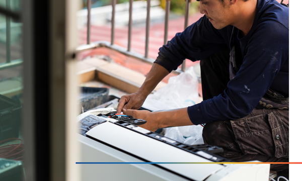 Man working on setting up air conditioner