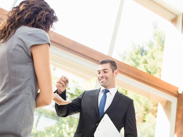 Real estate agent handing keys over to a new home.