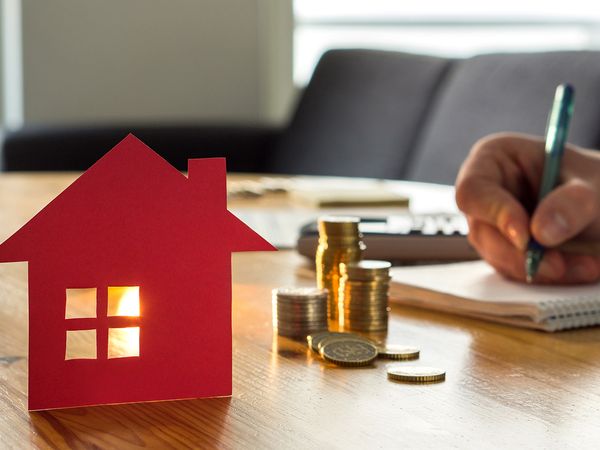 Man counting coins and costs for a home mortgage