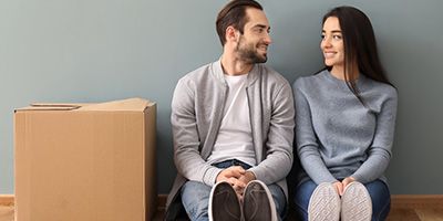 couple sitting next to box